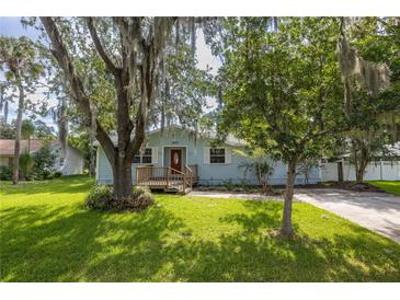 Charming single-story home featuring a well-maintained lawn and mature trees at 2617 Pine Tree Dr, Edgewater, FL 32141