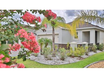 Charming single-Gathering home featuring a well-manicured lawn and beautiful landscaping around the property at 349 Caryota Ct, New Smyrna Beach, FL 32168