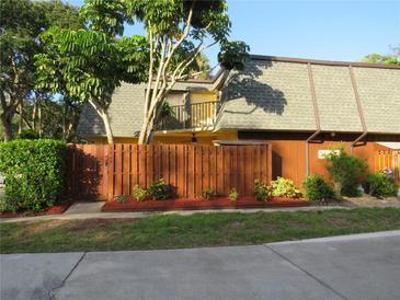 Charming home featuring a well-maintained yard, privacy fence, and lush greenery, creating a cozy and inviting atmosphere at 3824 Saxon Dr, New Smyrna Beach, FL 32169