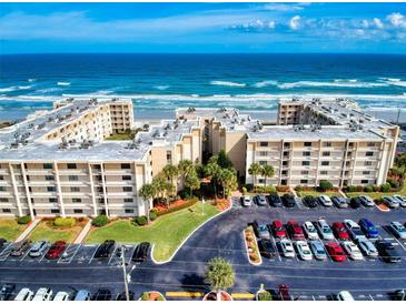 Beautiful aerial view of oceanfront condo complex with ample parking and beach access at 4175 S Atlantic Ave # 4110, New Smyrna Beach, FL 32169