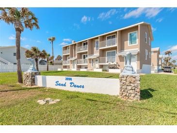Inviting Sand Dunes community with well-maintained landscaping and charming dolphin statues, exuding coastal charm at 2898 Ocean Shore Blvd # 5020, Ormond Beach, FL 32176