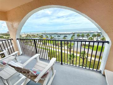 Inviting balcony with chairs overlooks the beach and ocean views at 30 Inlet Harbor Rd # 606, Ponce Inlet, FL 32127