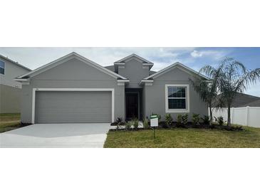 Charming single-story home with a well-manicured lawn and attached two car garage at 515 Ingleside Ln, Haines City, FL 33844