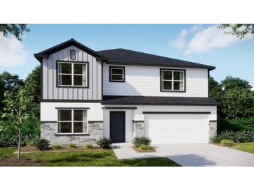 Two-story home with stone accents, white siding and a two car garage at 111 Addle Hill Ct, Deland, FL 32720