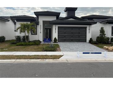 Move-in ready home with a two-car garage and landscaped yard at 3016 Kensington Ave, Davenport, FL 33837