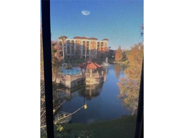 Scenic view of the community, with pool, gazebo, and fountain visible through the window at 12521 Floridays Resort Dr # 302F, Orlando, FL 32821