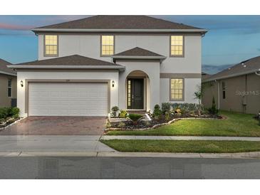 Charming two-story home with a two-car garage and well-maintained landscaping at 224 Trinity Ridge Cir, Davenport, FL 33897