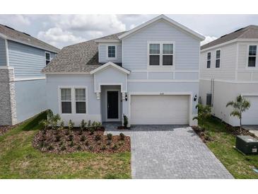 Charming two-story home features a two-car garage and well-maintained landscaping at 4189 Lana Ave, Davenport, FL 33897