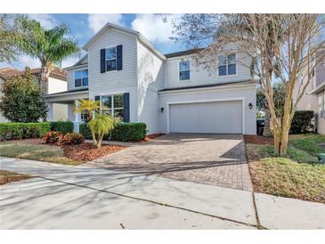 Charming two-story home featuring a two-car garage, brick driveway, and well-maintained landscaping at 9149 Outlook Rock Trl, Windermere, FL 34786