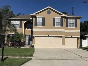 Charming two-story home with well-maintained landscaping, a two-car garage, and a welcoming front entrance at 466 Pepin Dr, Orlando, FL 32825