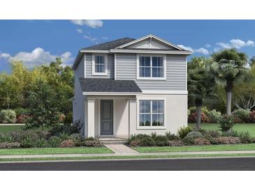 Charming two-story home with gray siding, manicured landscaping, and a welcoming front entrance at 2603 Long Pine Ave, Apopka, FL 32712