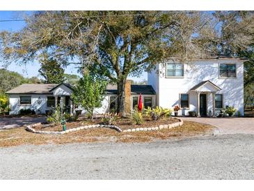 Two-story home with landscaped yard and large tree at 500 Freyer Dr, Longwood, FL 32750