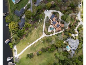 Aerial view of a home with a large yard, pool, and waterfront access at 208 Green Lake Cir, Longwood, FL 32779