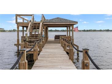 View of the outdoor wooden dock with gazebo and stairs that lead to an upper deck overlooking the water at 208 Green Lake Cir, Longwood, FL 32779