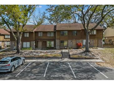 Charming townhome with mature trees, brick accents, and visitor parking at 4945 Sanoma Vlg # B, Orlando, FL 32808