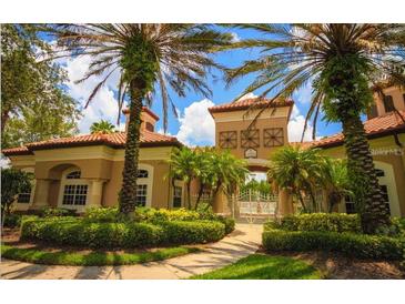 Beautiful community entrance with lush landscaping and a welcoming gate, creating an inviting atmosphere at 13917 Fairway Island Dr # 932, Orlando, FL 32837