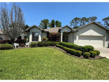 Single-story home with landscaped lawn and attached garage at 5021 Harbor Hts, Lady Lake, FL 32159