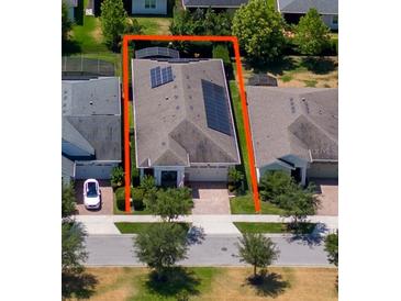 An aerial view of a single Gathering home with solar panels and manicured landscaping at 4904 W Fountainwood Dr, St Cloud, FL 34772