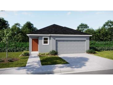 Charming single-story home featuring a gray exterior, attached two-car garage, and well-manicured landscaping at 2747 San Marco Way, Winter Haven, FL 33884