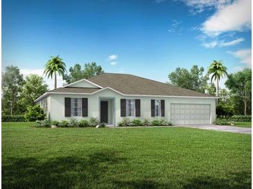 Single-story home with a two-car garage and a well-manicured lawn at 704 Village Ct, Fruitland Park, FL 34731