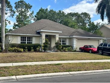 Charming single story home with a well-manicured lawn, attached two car garage and covered entryway at 1201 Thornbury Ct, Winter Garden, FL 34787
