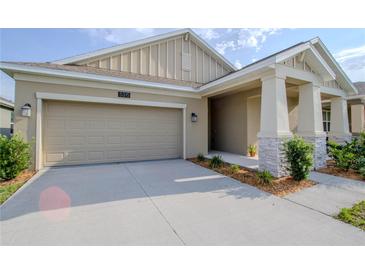 Charming single-story home featuring a two-car garage, covered porch with columns, and well-maintained landscaping at 5315 Amersham Ln, St Cloud, FL 34771