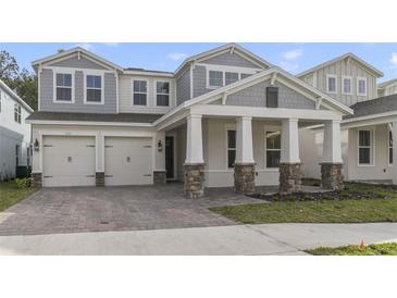 Charming two-story home featuring a two-car garage, stone accents, and a welcoming front porch at 231 Severn Way # 36, Orlando, FL 32803