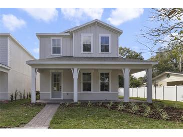 Charming two-story home featuring a welcoming front porch, manicured lawn, and modern architectural design at 2138 Forest Cir # 32, Orlando, FL 32803