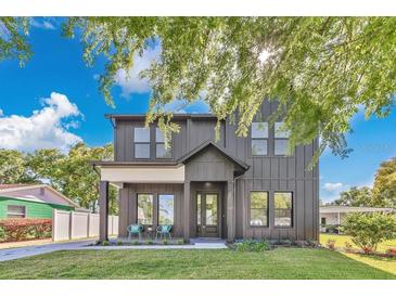 Beautiful two-story home featuring a modern farmhouse design with a well-manicured lawn and tasteful landscaping at 3480 Fairway Ln, Orlando, FL 32804