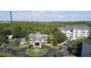 A beautiful community featuring a clubhouse, pool, and lush landscaping at 3176 Feltrim Pl # 305, Kissimmee, FL 34747