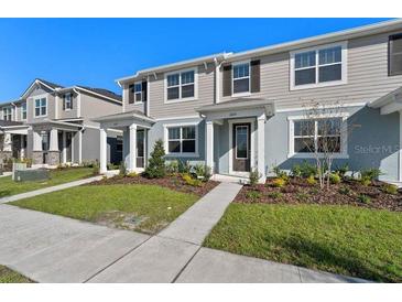 Charming townhouse with a well-manicured lawn and inviting entrance, perfect for modern living at 3225 Douglas Fir Dr, Apopka, FL 32703