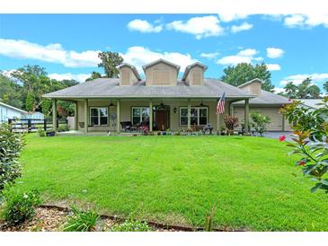 Beautiful two-story house with a large front yard and porch at 33412 E Lake Joanna Dr, Eustis, FL 32736