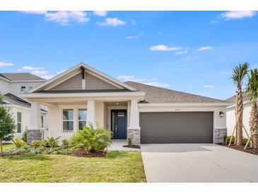 Charming single-story home with a two-car garage, well-manicured lawn, and beautiful landscaping at 4678 Ackee Rd, Kissimmee, FL 34758