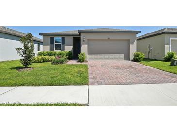 Charming single-story home featuring a brick driveway and well-maintained landscaping at 3158 Viceroy Ct, Poinciana, FL 34759