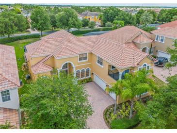 Luxury two-story home with tile roof, large driveway, and lush landscaping at 334 Chadwick Dr, Davenport, FL 33837