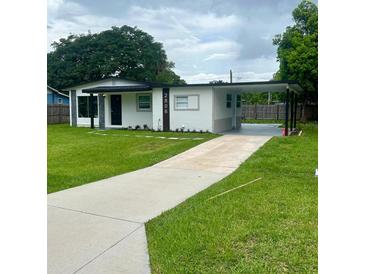 Charming single-story home with well-manicured lawn, carport, and freshly painted exterior at 2806 Bonneville Dr, Orlando, FL 32826