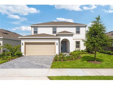 Charming two-story home featuring a landscaped front yard and a two-car garage at 2288 Sirena Ln, Mount Dora, FL 32757