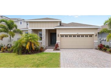 Charming single-Gathering home featuring a paver driveway, attached garage and well-maintained landscaping at 2280 Sirena Ln, Mount Dora, FL 32757