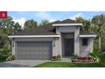 Charming single-story home featuring a gray exterior, well-manicured lawn, and a spacious two-car garage at 2284 Sirena Ln, Mount Dora, FL 32757