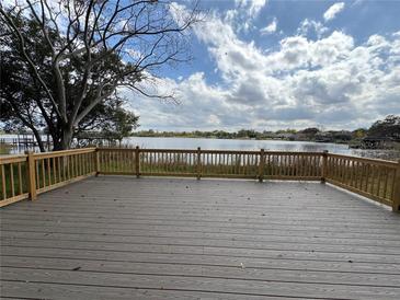 A spacious deck overlooks a serene lake, offering a perfect spot for relaxation and outdoor enjoyment at 4808 Anderson Rd, Orlando, FL 32812