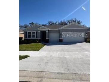 Charming single-story home featuring a well-manicured lawn, a two-car garage, and neutral-toned siding at 3443 Islewood Ct, Ocoee, FL 34761