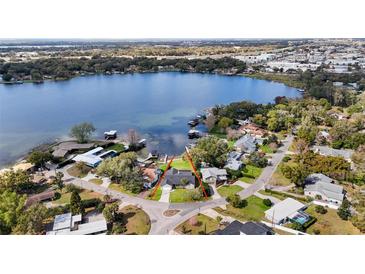 Stunning lakefront property with lush landscaping and private dock access to the beautiful blue lake at 301 Richard Pl, Orlando, FL 32806