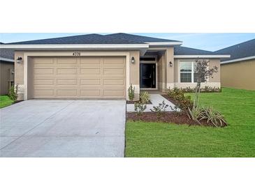 New single-story home with a two-car garage and landscaped front yard at 4376 Sagefield Dr, Harmony, FL 34773