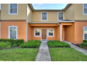 Charming townhome featuring a well-maintained lawn and inviting front entrance at 4032 Mountain Chestnut Way, Lakeland, FL 33812