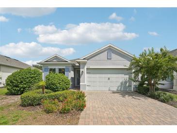 Charming single-Gathering home featuring a two-car garage, paver driveway, and fresh landscaping at 2132 Antilles Club Dr, Kissimmee, FL 34747