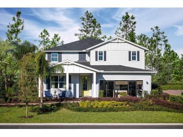 Two-story home featuring a meticulously landscaped front yard and charming architectural details at 2424 Park Ridge St, Apopka, FL 32712