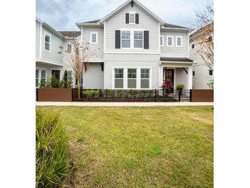 Two-story house with gray siding, black shutters, and a manicured lawn at 790 Candlebrush Ln, Lake Mary, FL 32746