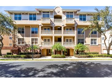 Beautiful multi-story condo building with balconies and lush landscaping at 913 Lotus Vista Dr # 101, Altamonte Springs, FL 32714