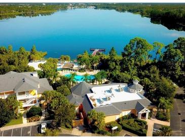 Aerial view of community amenities including pool, lake, and clubhouse at 113 Rogues Retreat, Davenport, FL 33897