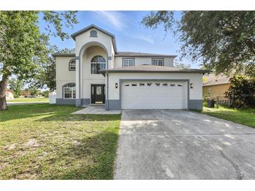 Charming two-story home with a well-maintained lawn, attached two car garage, and beautiful curb appeal at 724 Tahiti Dr, Kissimmee, FL 34758